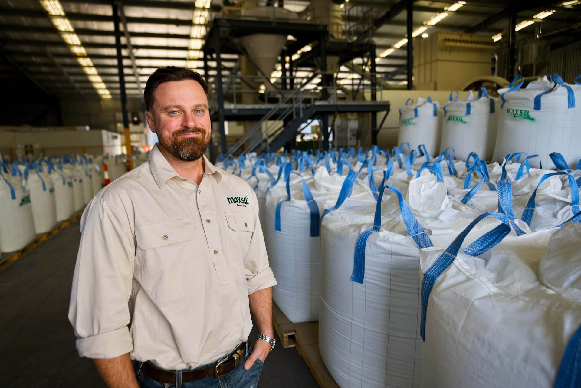 Brendan Lloyd, co-founder of Sustainable Concrete, in the Brendale warehouse with MaxSil bulk bags
